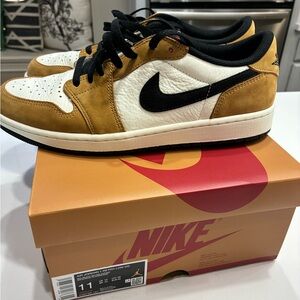 Air Jordan 1 Retro Low OG shoes in Men’s 11.
The color Sail/Black-Golden Harvest